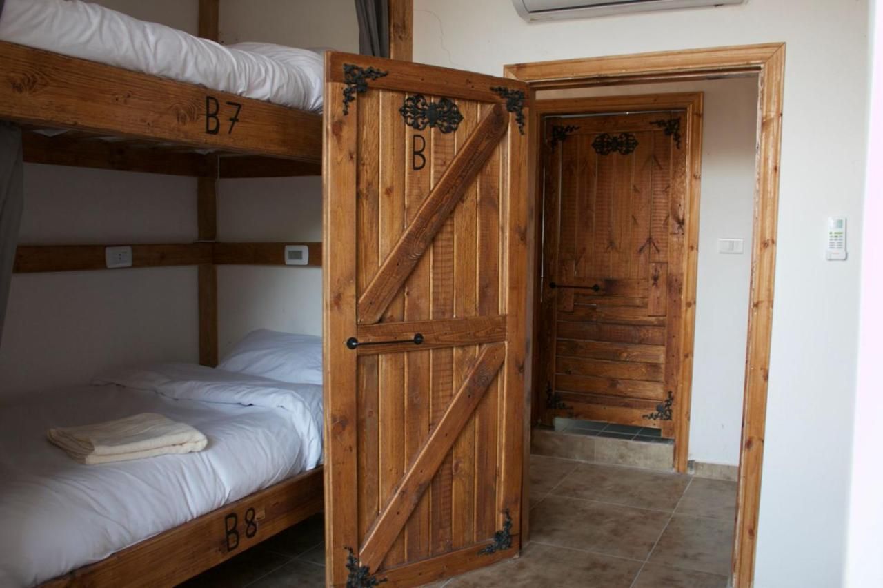 Mixed dorm bunks and wooden door
