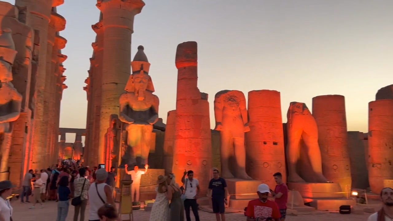 Luxor Temple lit at dusk, the colossi of Ramses II in gold
