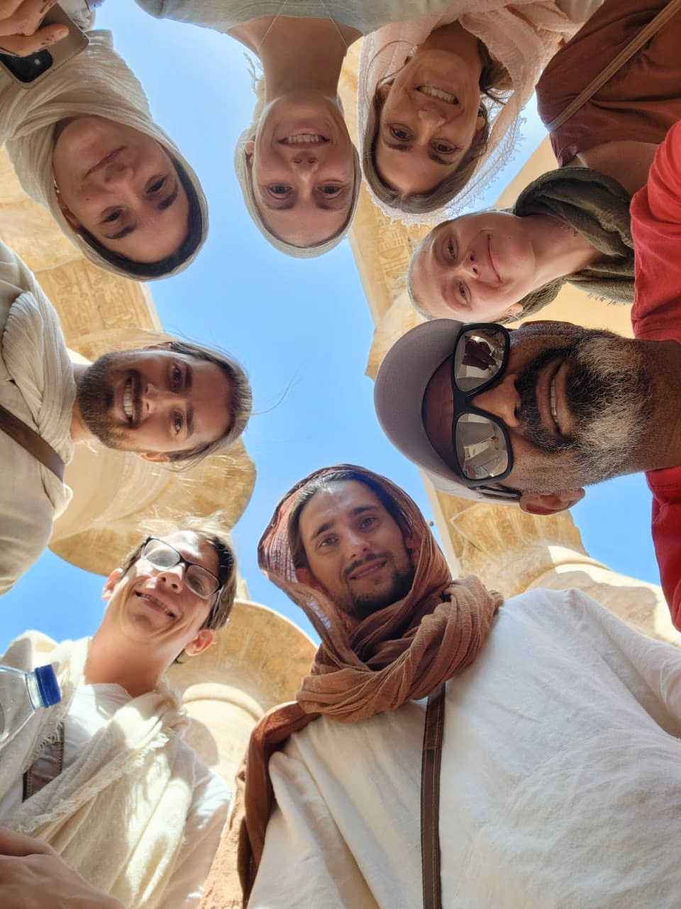 The group looking down into the camera, sky behind