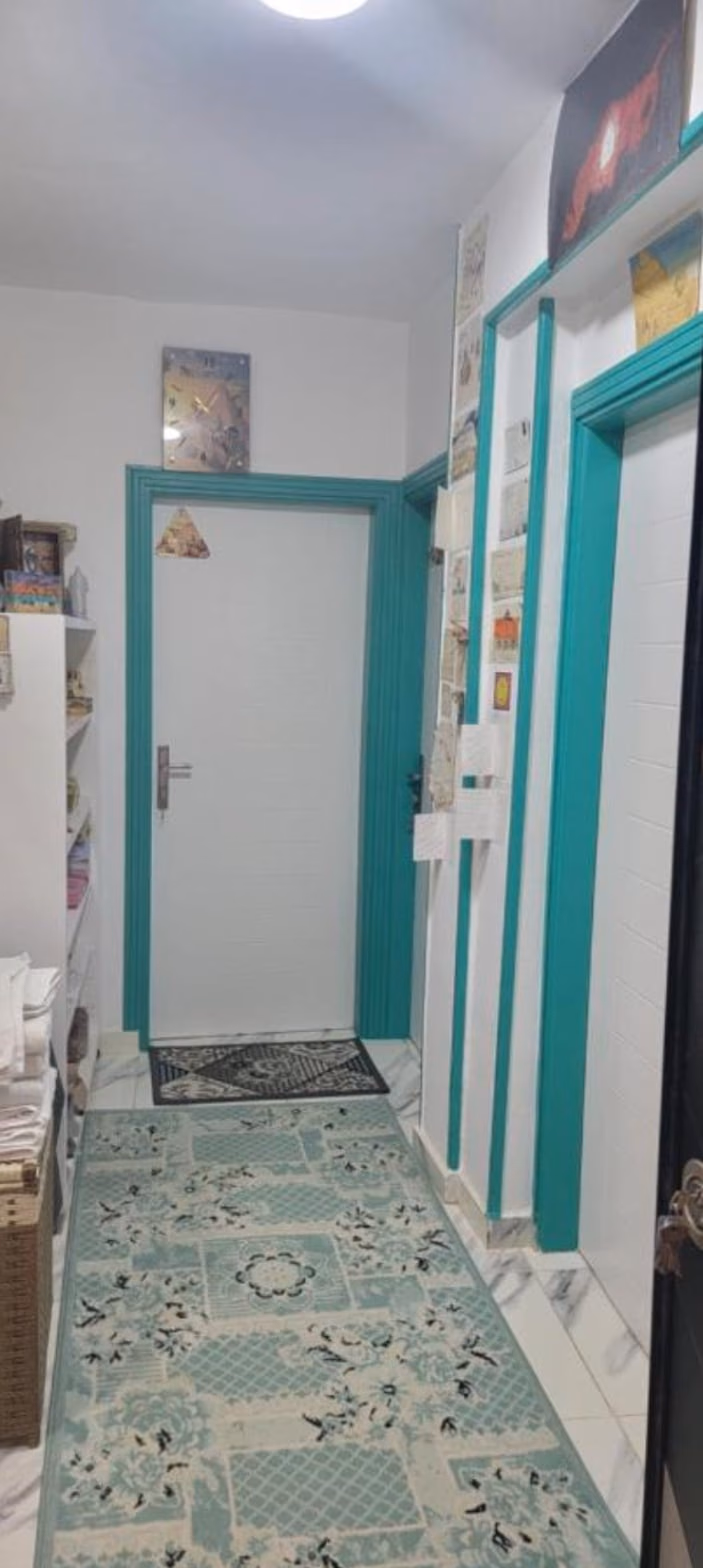 The corridor, with postcards from past guests on the wall