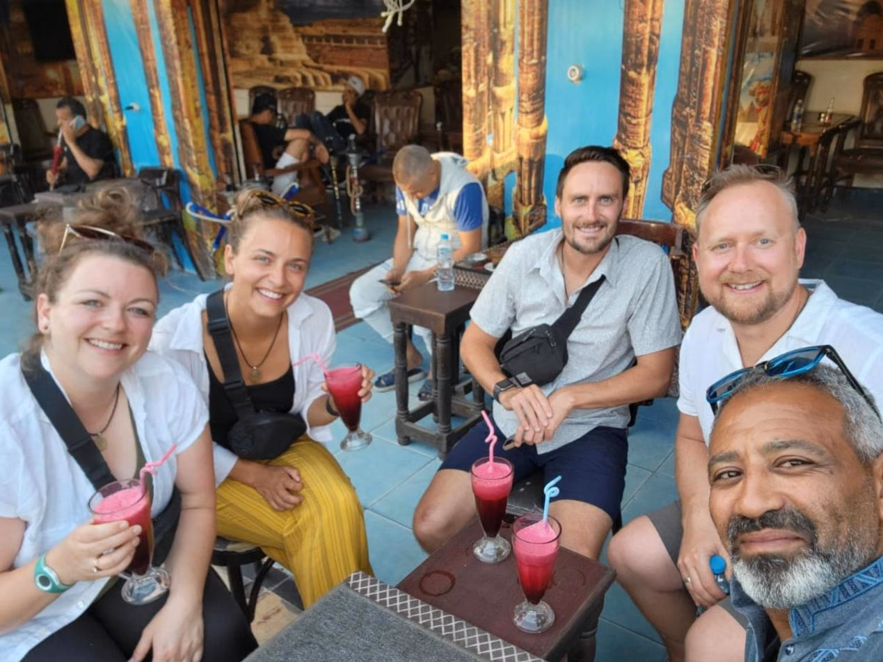 Rami and guests with fresh juice at a café