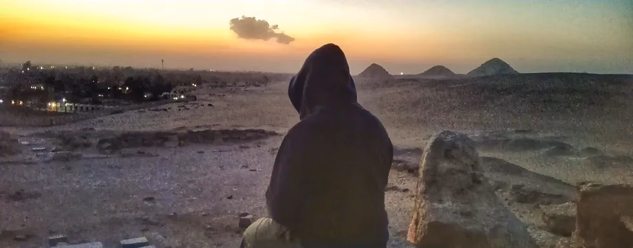 Watching the sun set over the pyramids from the desert