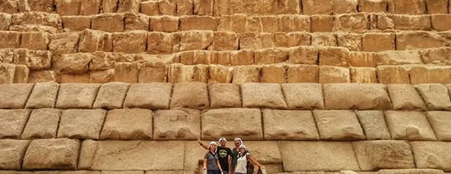 Guests dwarfed by the limestone blocks of the Great Pyramid