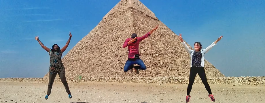 Guests jumping for joy in front of the pyramid