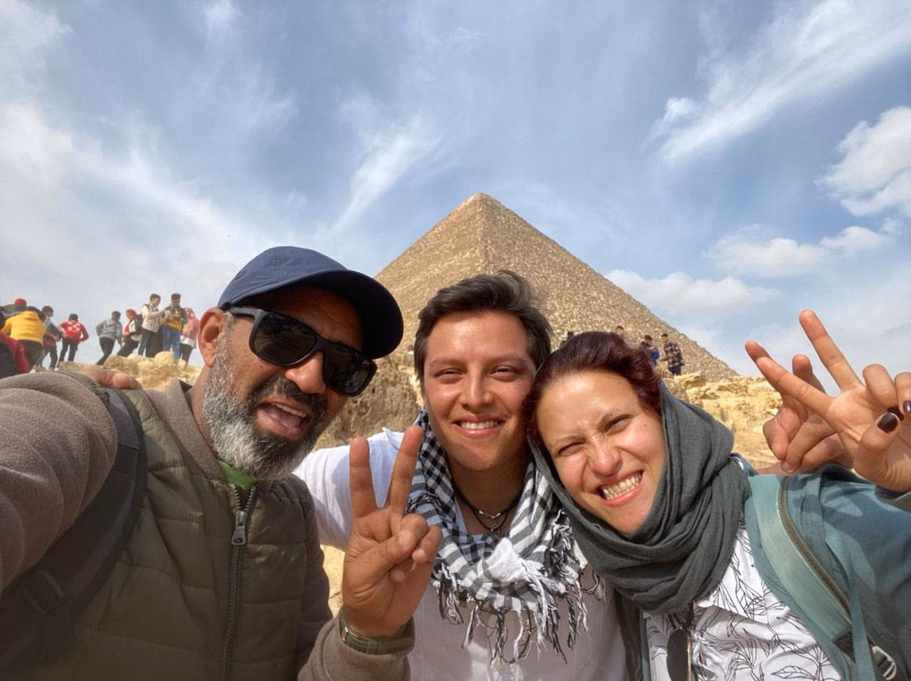 Rami with two guests, pyramid behind
