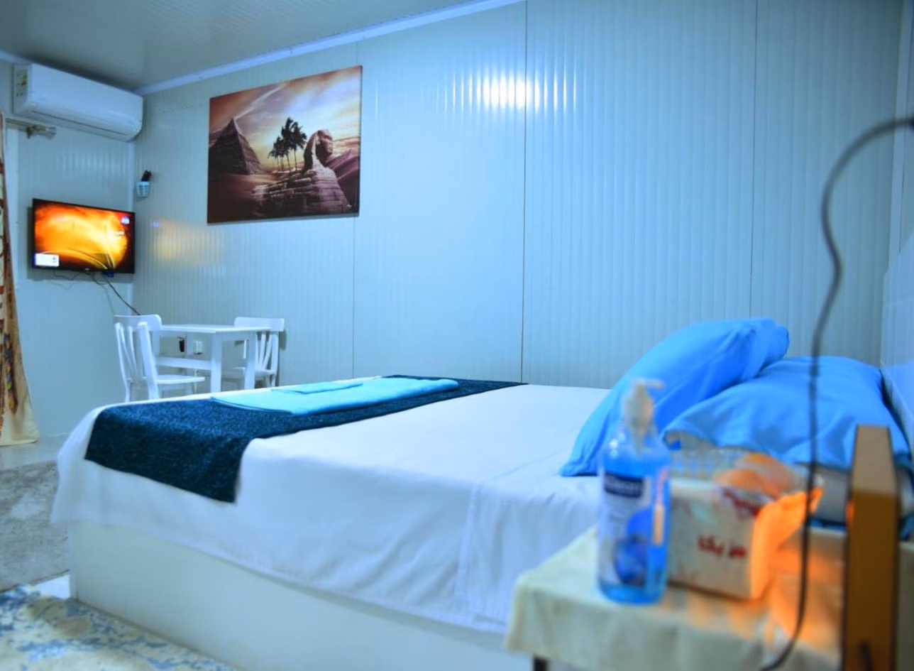 Room 4: bed, table for two and a Sphinx painting