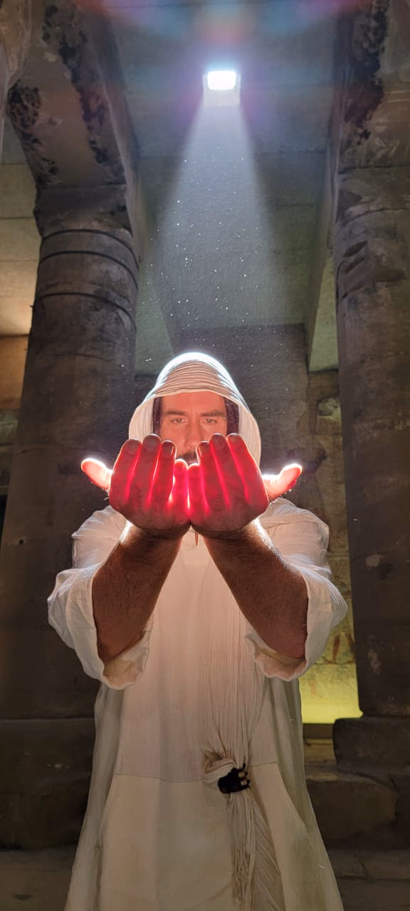 A guest in a shaft of light inside a temple